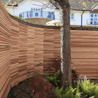 Fence panel attached to a curved wall