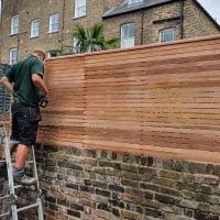 wall top fencing being installed.