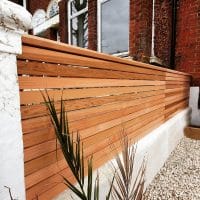 Cedar square edge fencing on top of wall