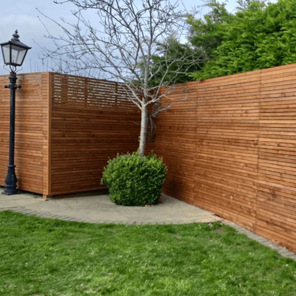 Venetian slatted fence panels in a neat garden