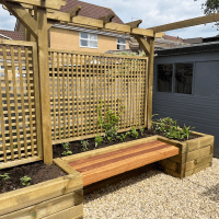 An example of how a Cedar floating bench can be positioned in a garden; suspended by the placement of planter boxes.