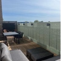 A terrace with a painted slatted fencing surround.