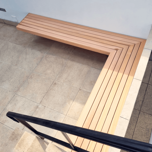 A Red Cedar garden corner bench. A contemporary seat with a simple L shaped design.